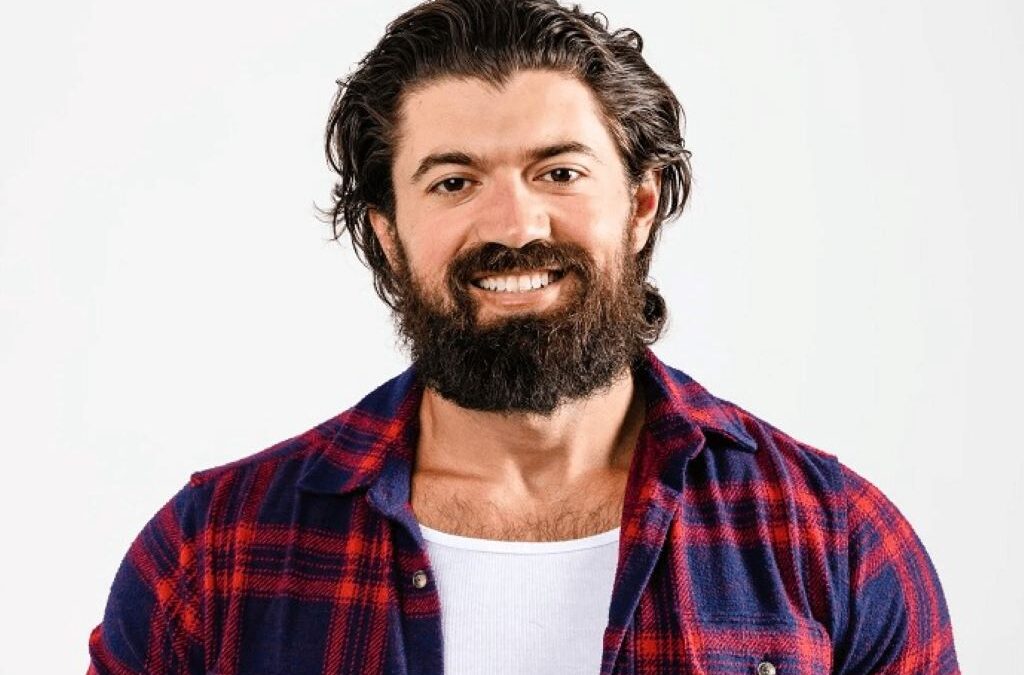 Portrait of Alex Hormozi with graphics showing his $100M+ business empire and fitness achievements