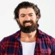 Portrait of Alex Hormozi with graphics showing his $100M+ business empire and fitness achievements