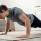 Person performing a bodyweight workout at home, demonstrating exercises without any equipment, emphasizing strength and fitness