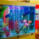 Aquarium air pump connected to flexible tubing with bubbles rising in fish tank