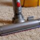 1. Dyson Ball vacuum cleaner on thick plush carpet showing proper positioning and height adjustment for smooth gliding