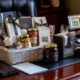 1. Professional business gift basket with gourmet items and elegant packaging on executive desk