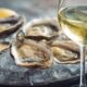 Fresh oysters on ice with glass of mineral white wine