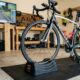 Adjustable bike riser block placed under front wheel of road bike on indoor trainer