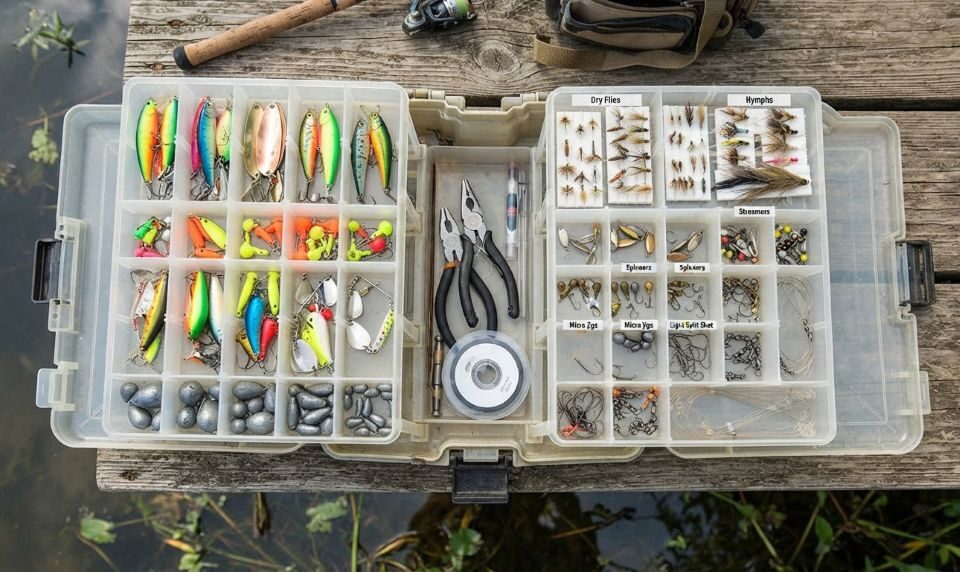 Essential fishing gear arranged in a tackle box